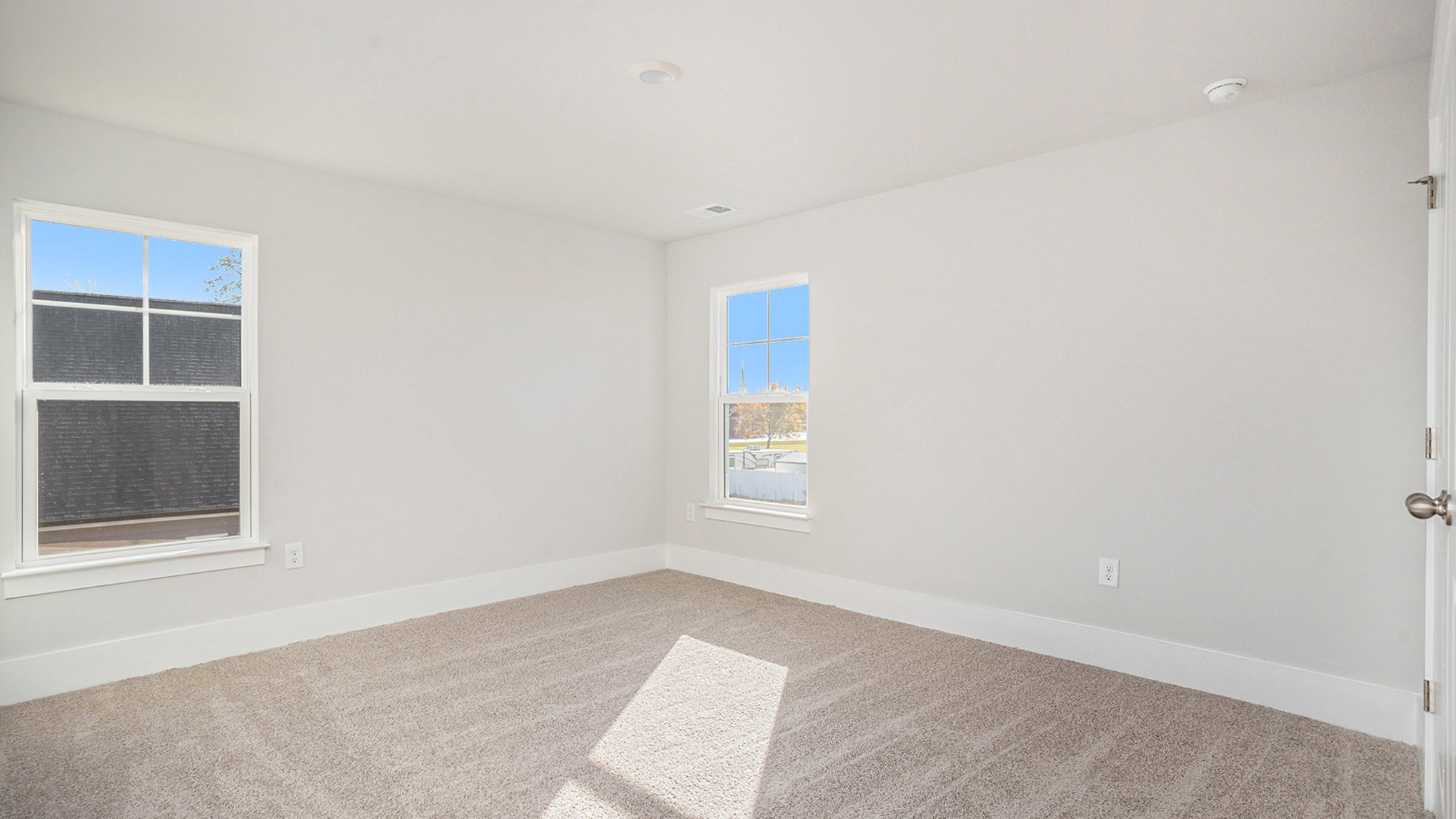 Bedroom 3 with 2 windows and carpet flooring