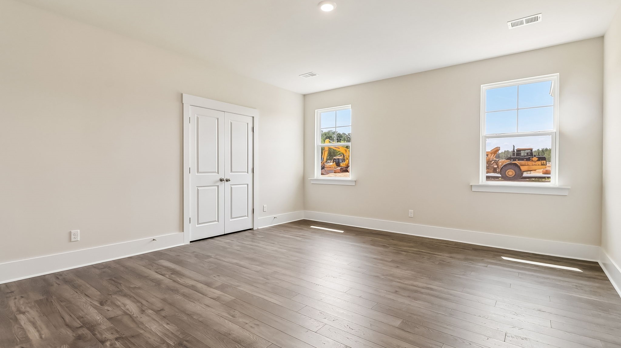 Primary bedroom with 2 large windows for light and RevWood floors