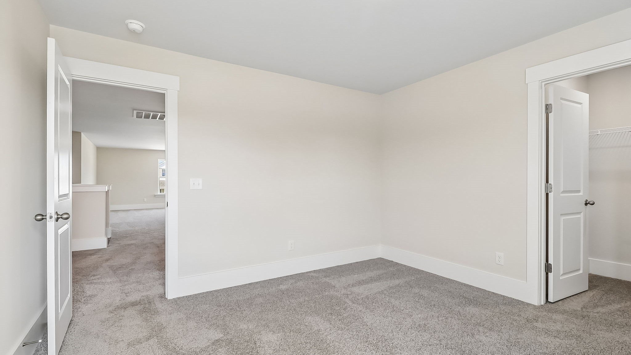 Bedroom 4 with a walk-in closet and carpet flooring in new home for sale in Gilbert, SC