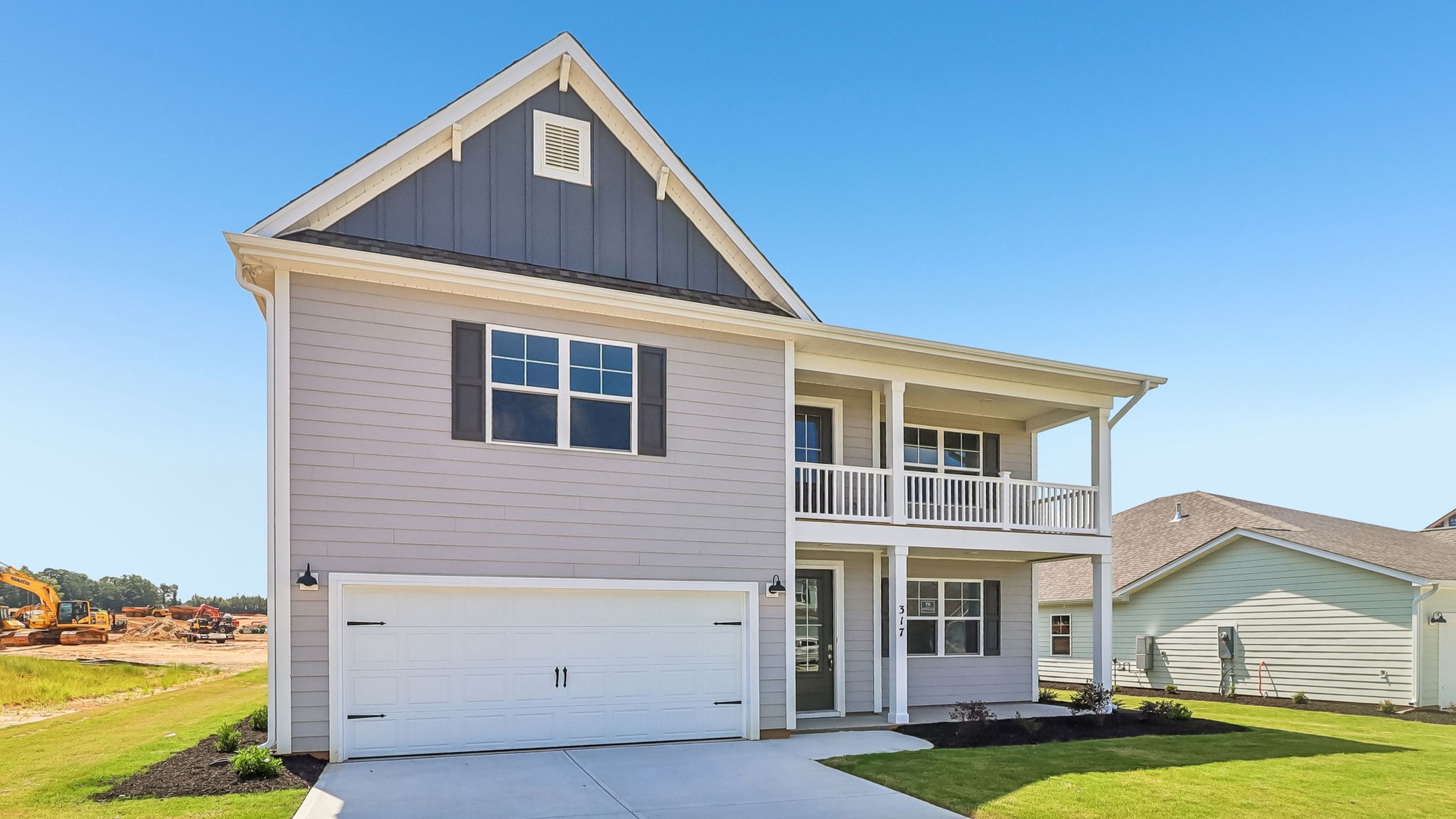 2-car garage, stacked porches, and board and batten accents on the front of the home for sale in Gilbert, SC