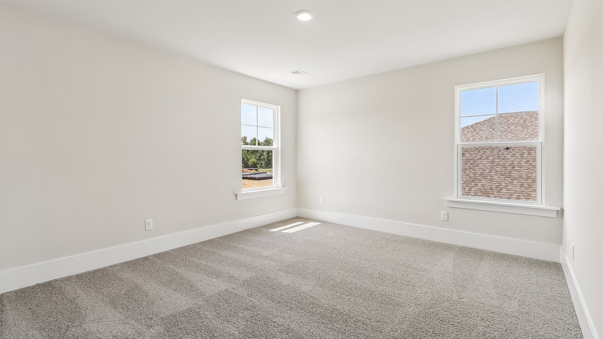 Bedroom 3 with 2 windows and carpet flooring