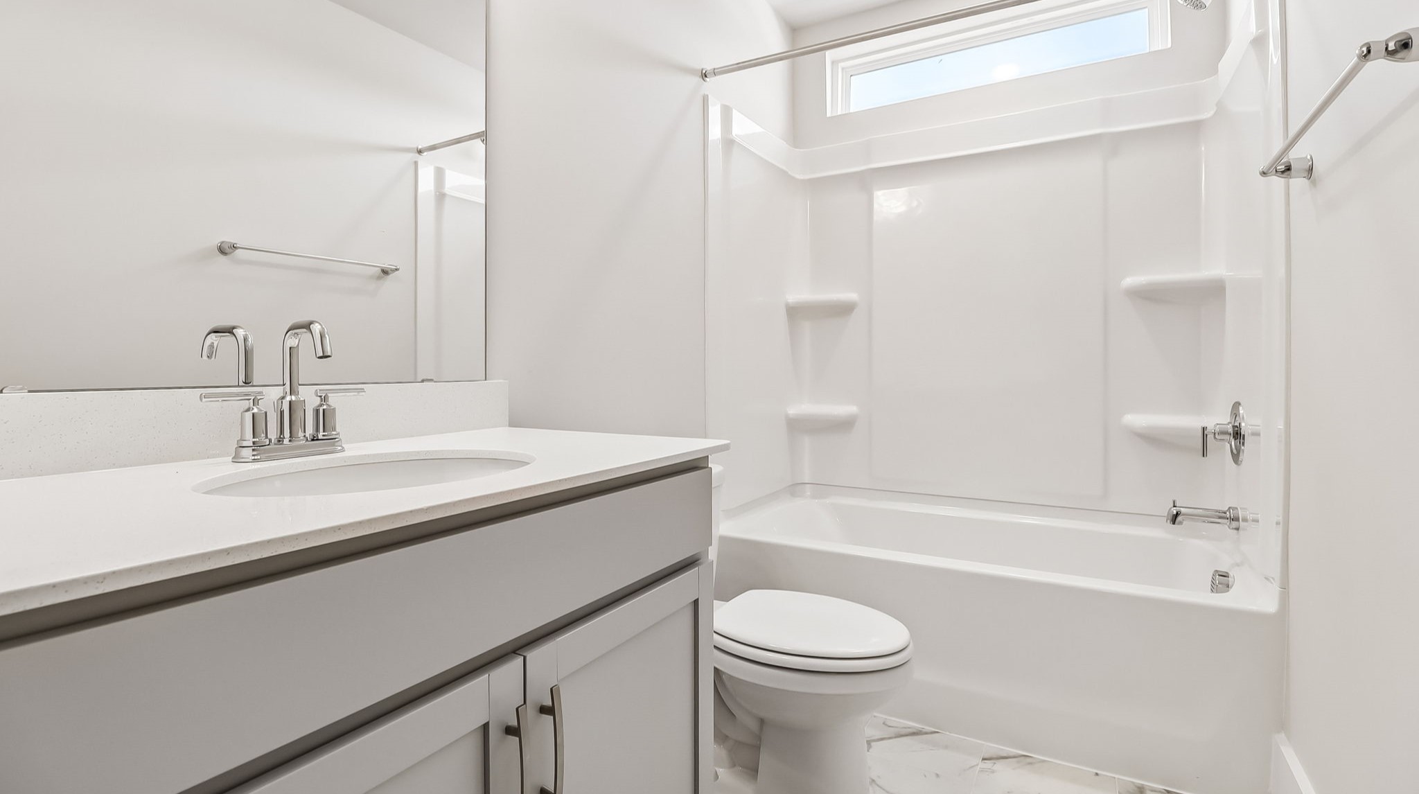 Bathroom 2 upstairs with a shower tub and single vanity with gray cabinetry and quartz countertops