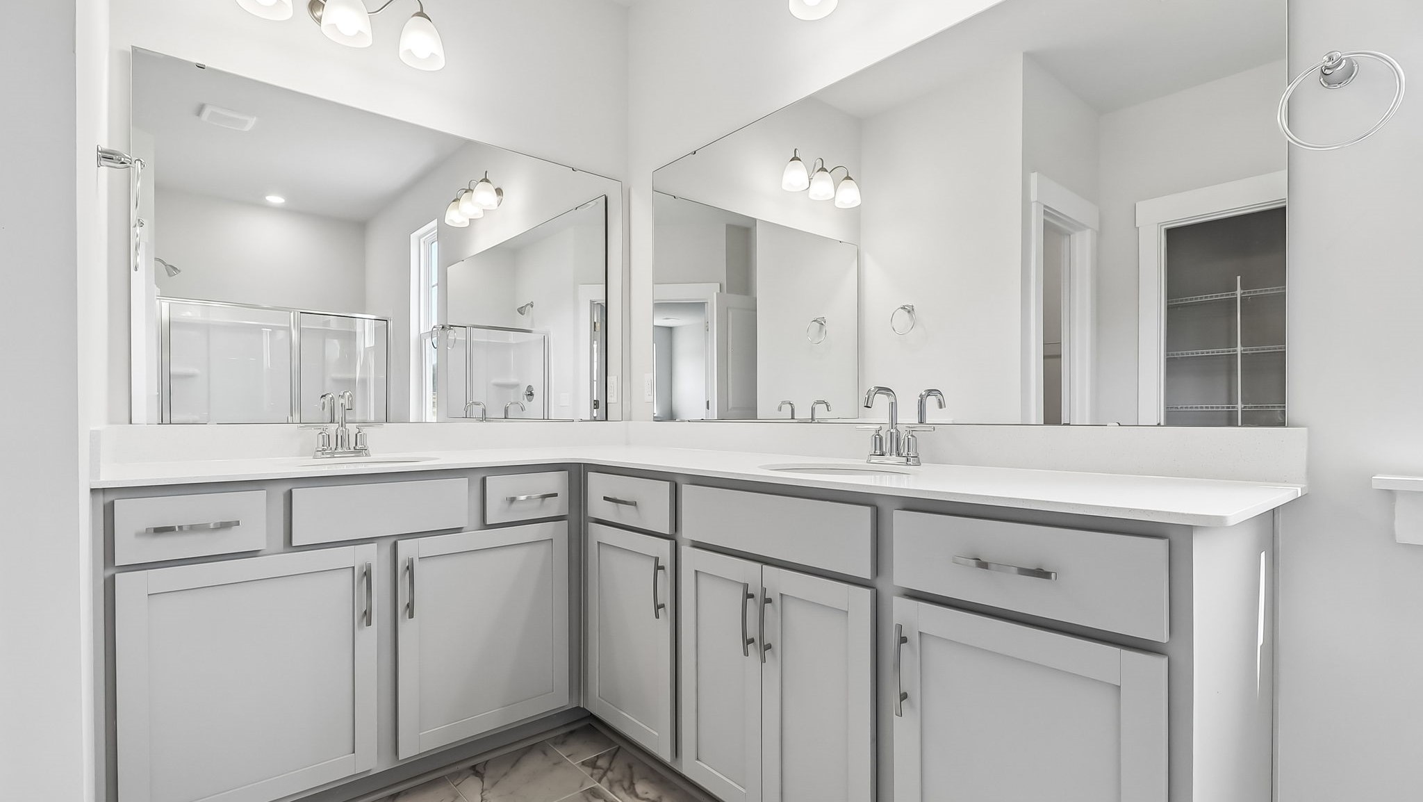 En-suite bathroom with dual vanities and quartz countertops