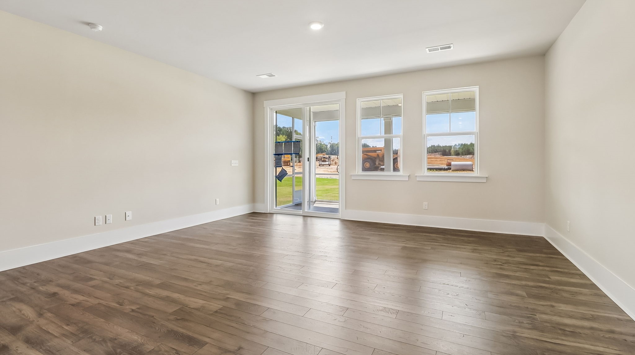Spacious living area with access to back patio and windows facing the backyard in Shell Pointe