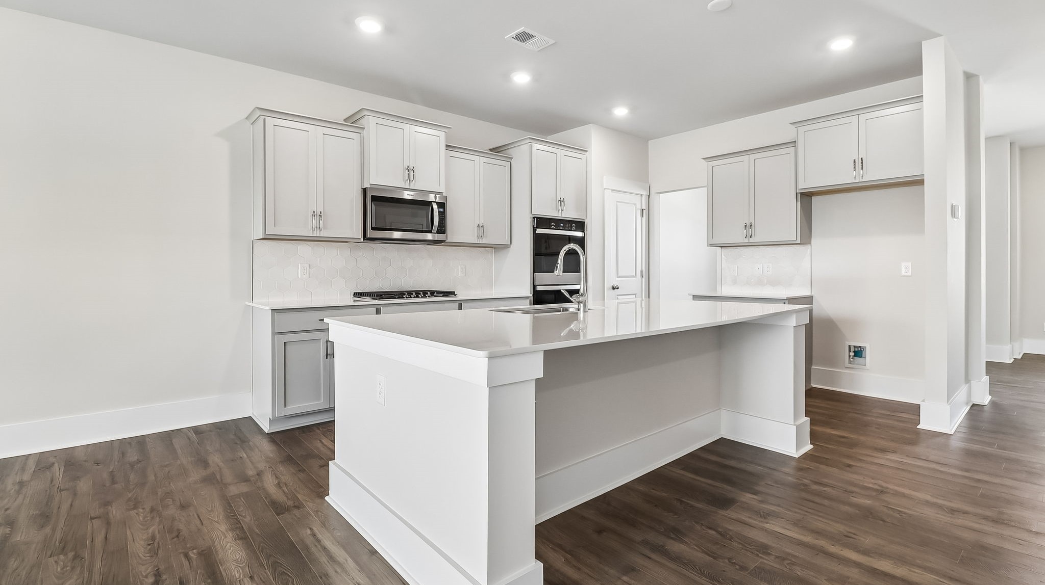 Tillman kitchen with light gray cabinetry and a floating kitchen island