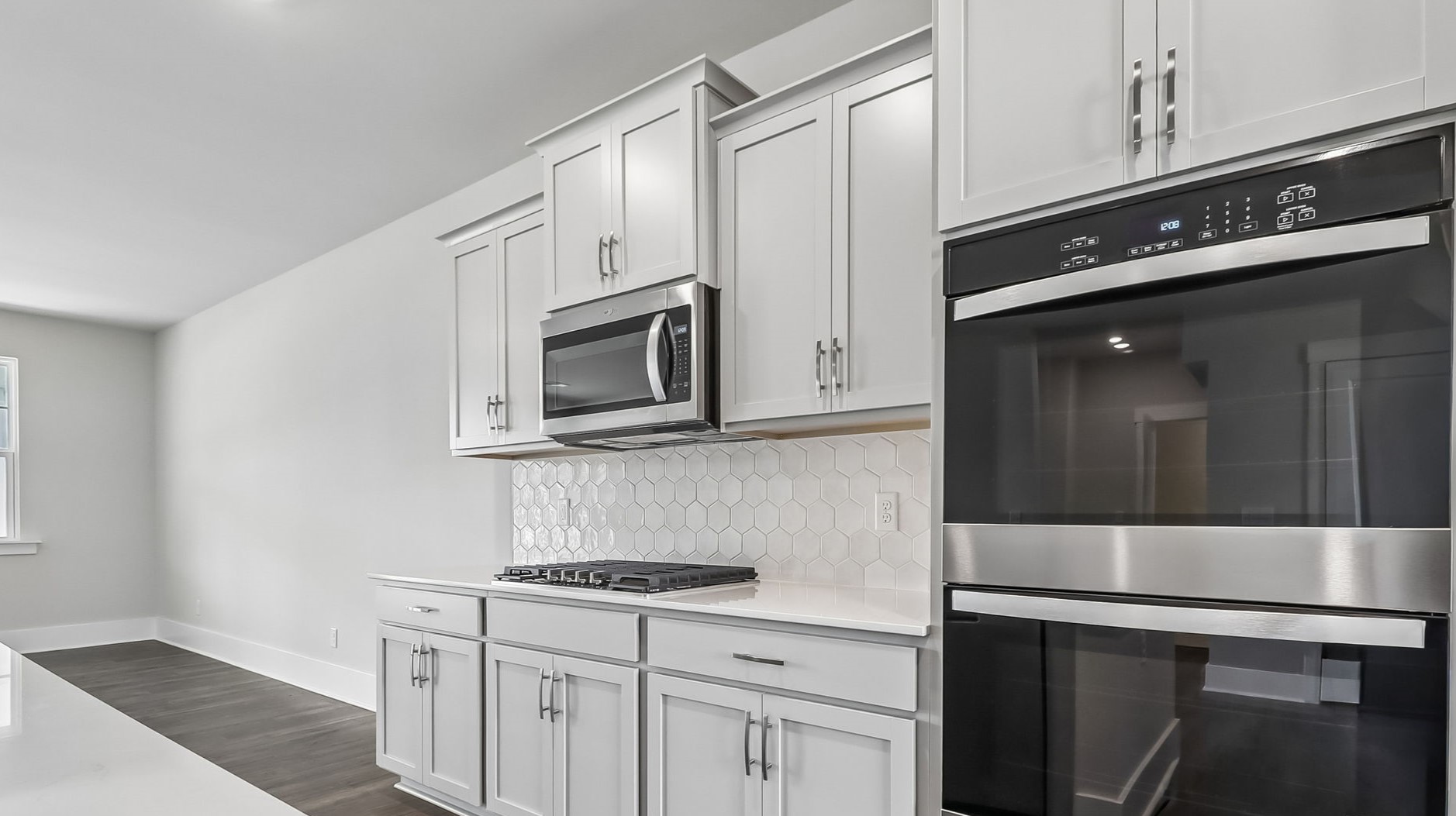 Double wall ovens come in the new kitchen and a built-in microwave above the cooktop