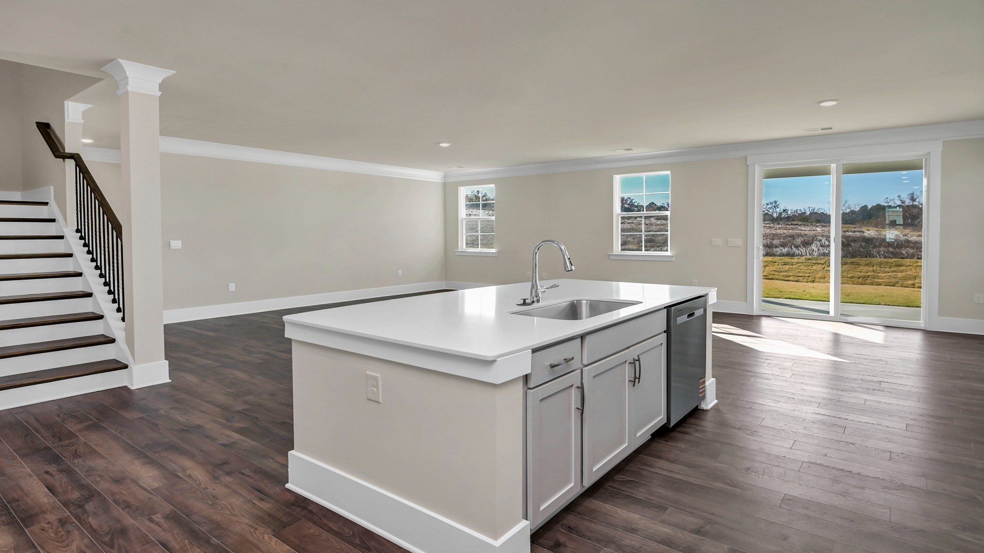Floating kitchen island overlooks dining and living areas