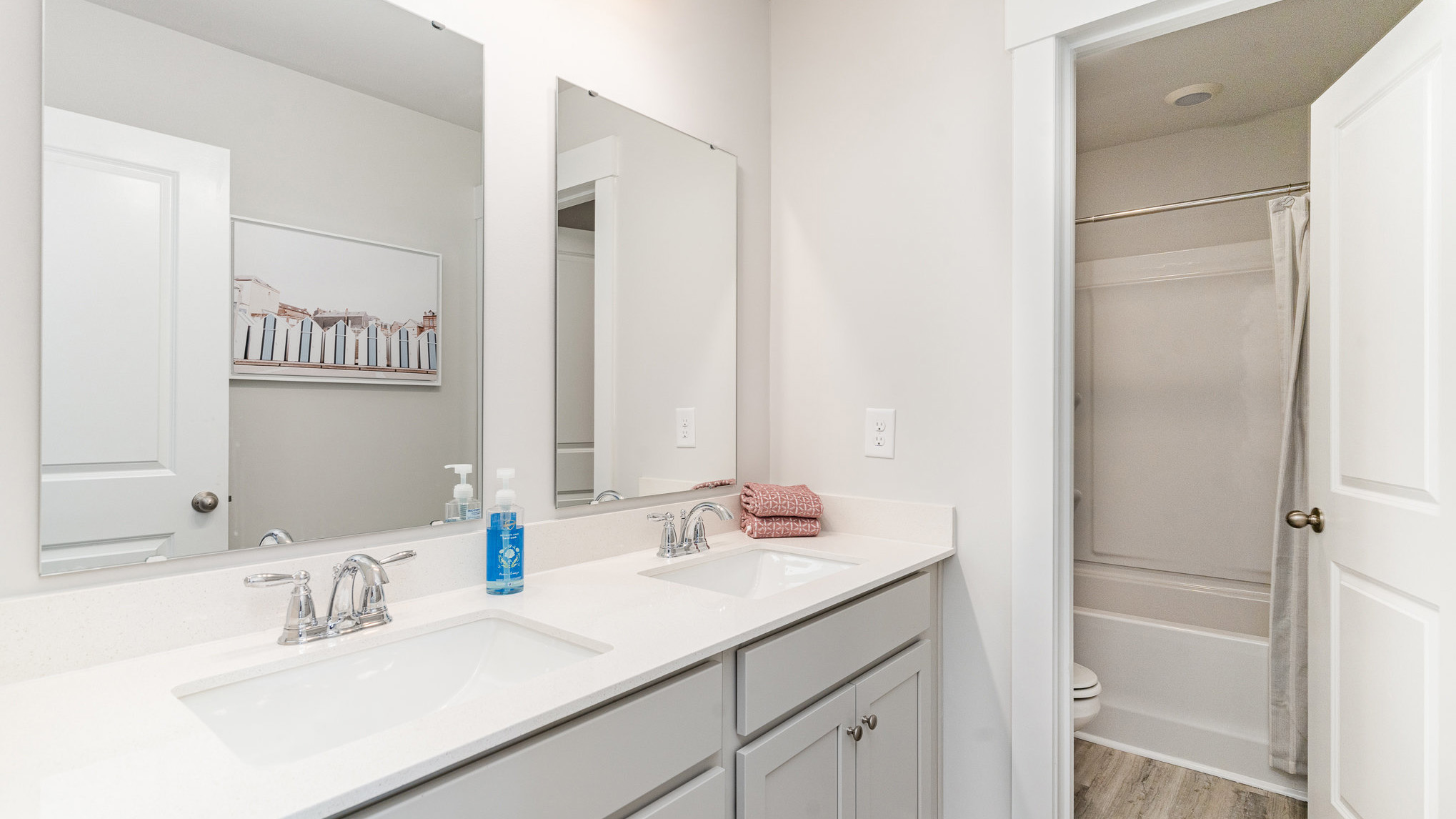 Bathroom 3 upstairs with double vanity and a shower/tub combo