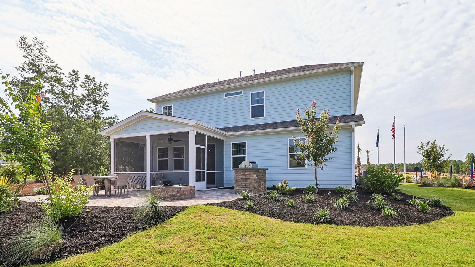 Two-story home with light blue Hardie Plank siding and a screened-in covered back patio