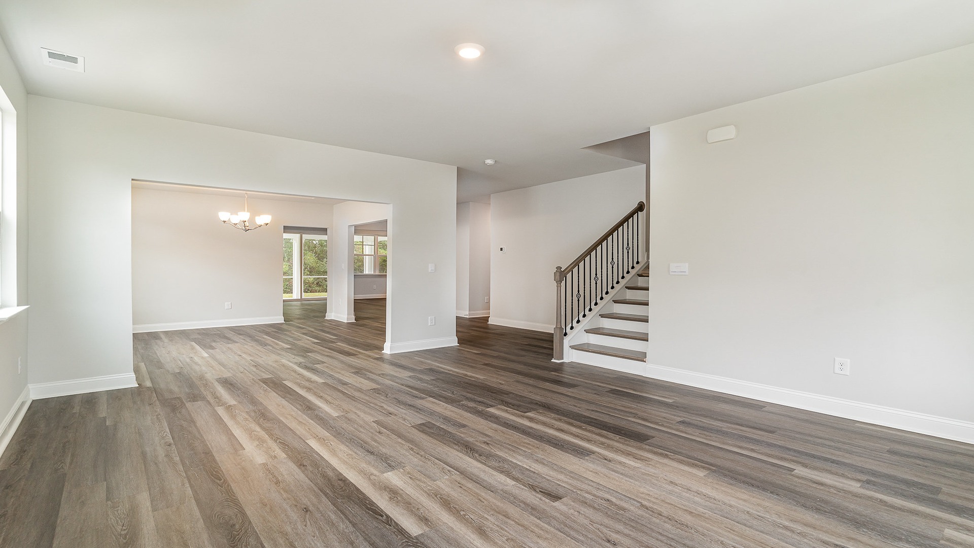 Living area with RevWood floors and upstairs access