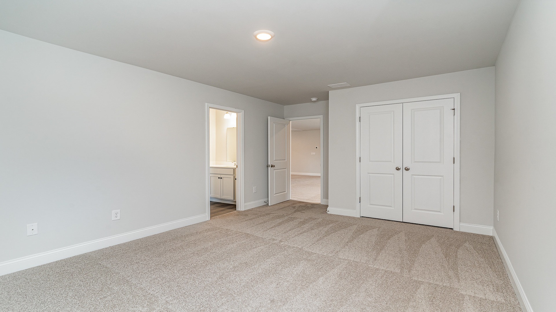 Bedroom 3 upstairs with carpet flooring and French closet doors