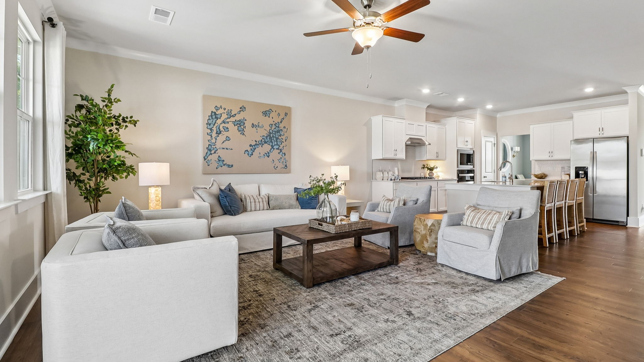 Completely open living and kitchen areas with lots of natural light and matching RevWood floors