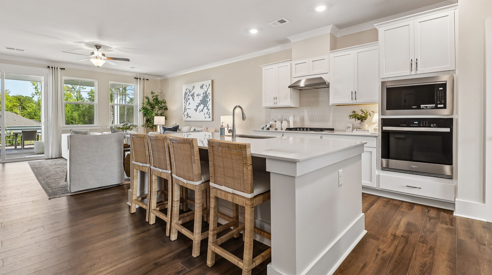 Modern kitchen space in new construction model home with quartz countertops and a floating island