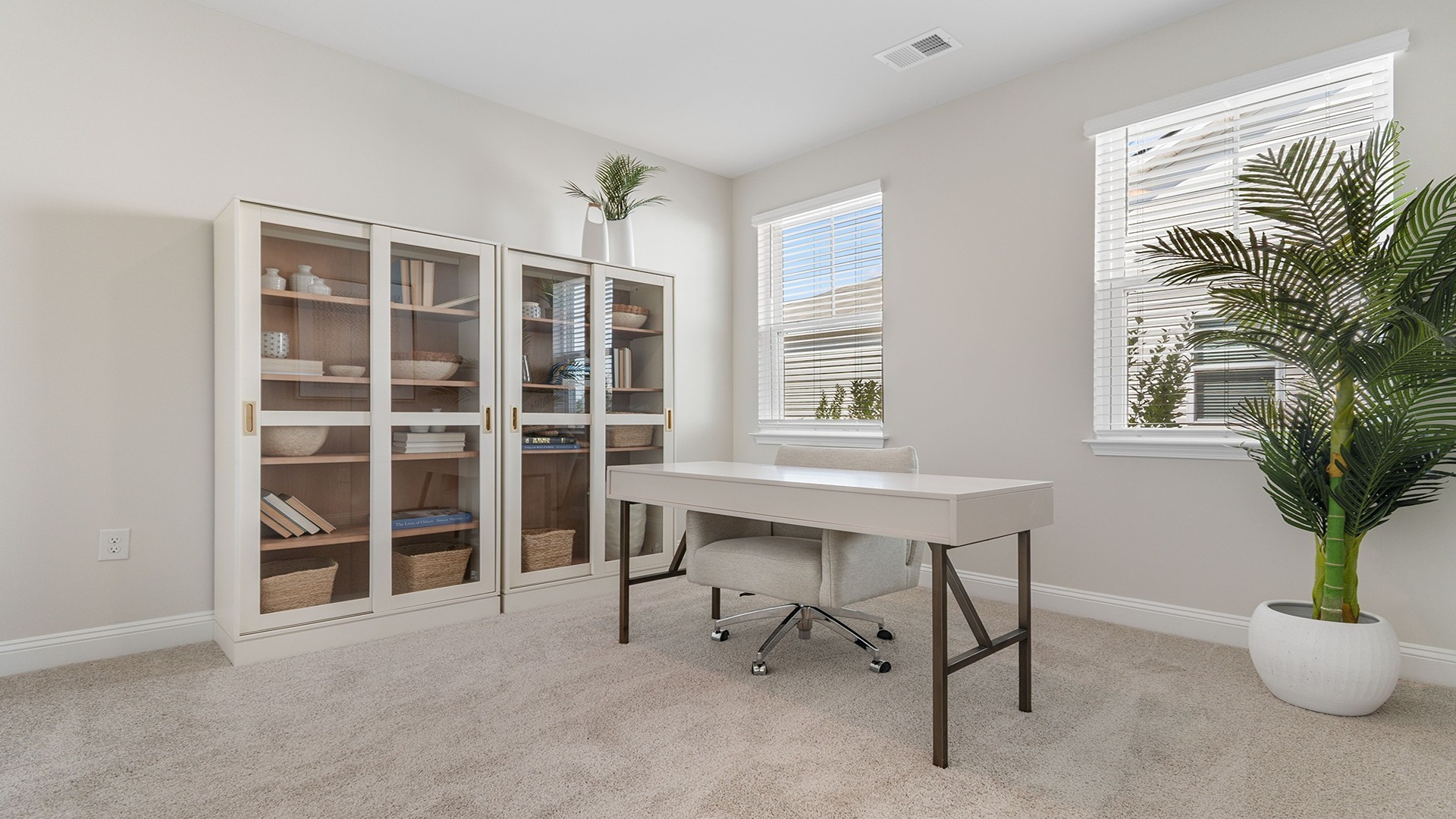 Front bedroom staged as a home office with natural light