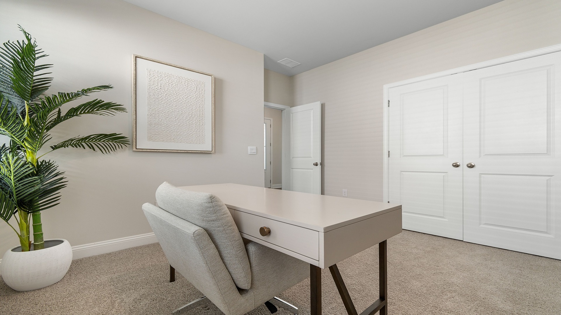 Carpet flooring and private closet in the front bedroom of the Eaton floorplan