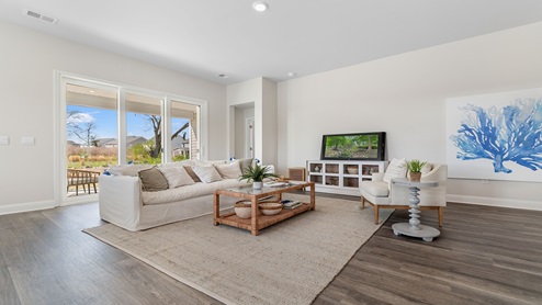 The living area is spacious with access to the back patio through glass sliding doors