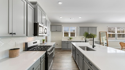 Quartz countertops and tile backsplash in the kitchen