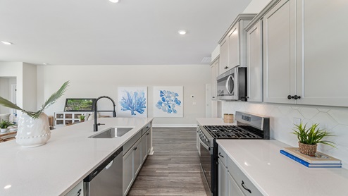Quartz countertops and tile backsplash in the kitchen
