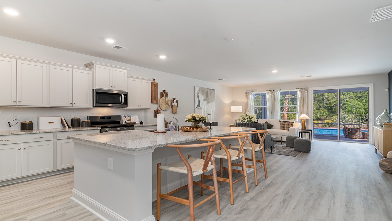 Tillman kitchen with sleeo countertops and white cabinetry in Old Chapin Reserve