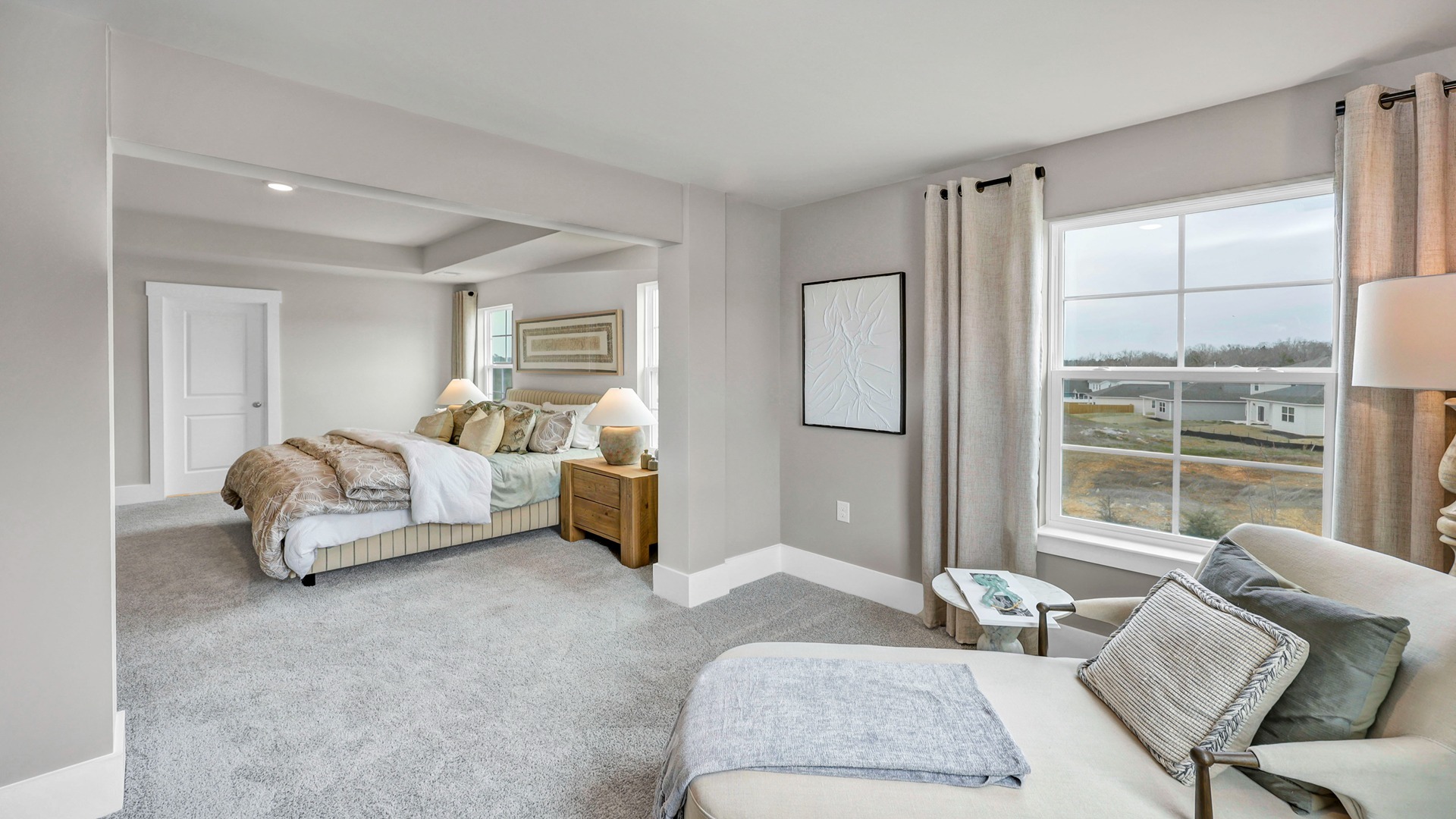 Primary sitting room and primary bedroom flow seamlessly together