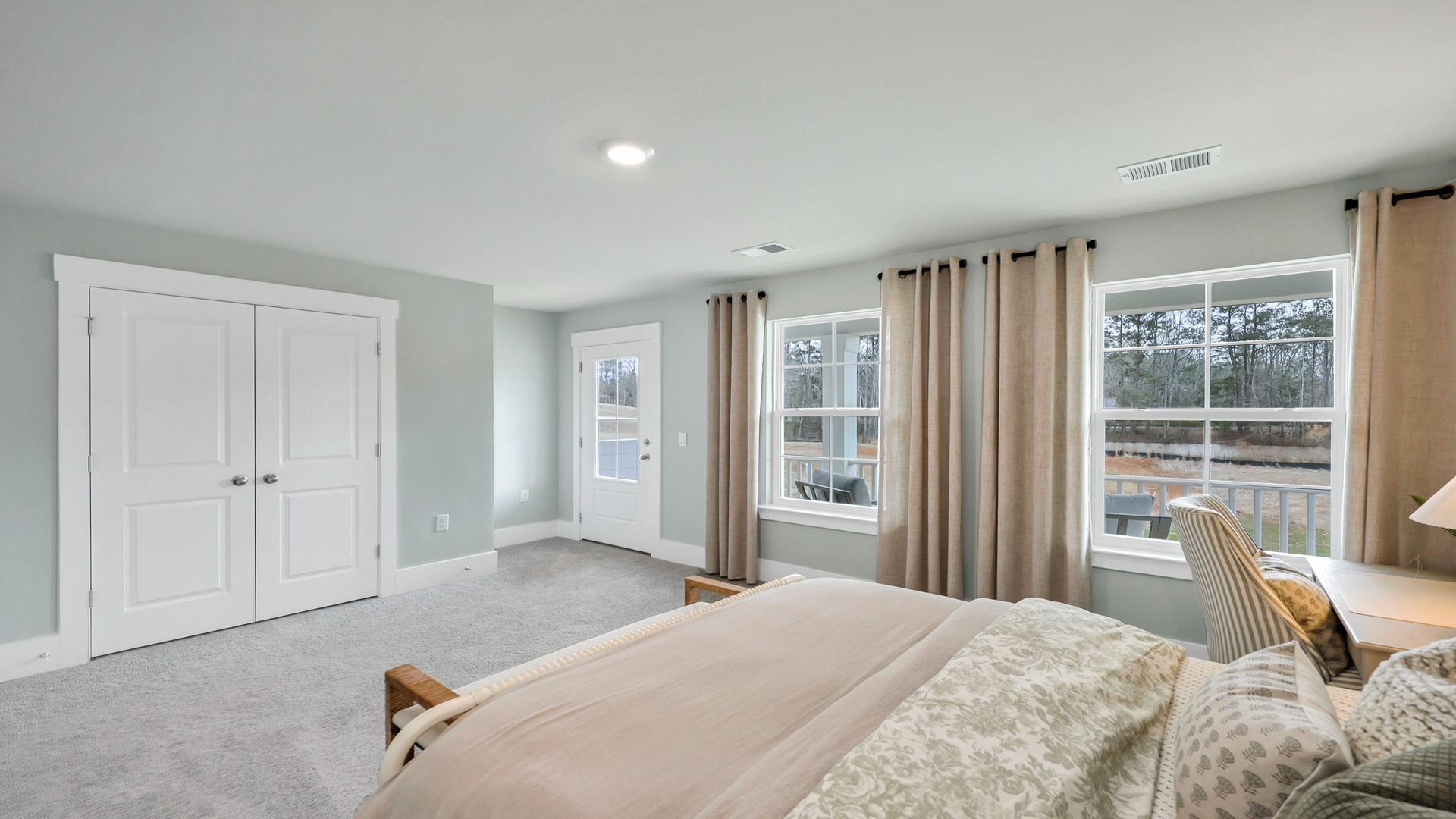 Carpet flooring and large windows in bedroom 3
