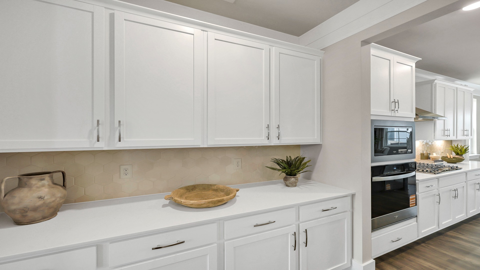 White cabinetry and quartz countertops in Harbor Oak kitchen