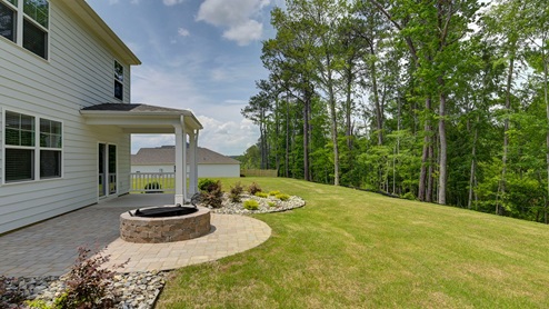 Back exterior of the home and the spacious backyard.