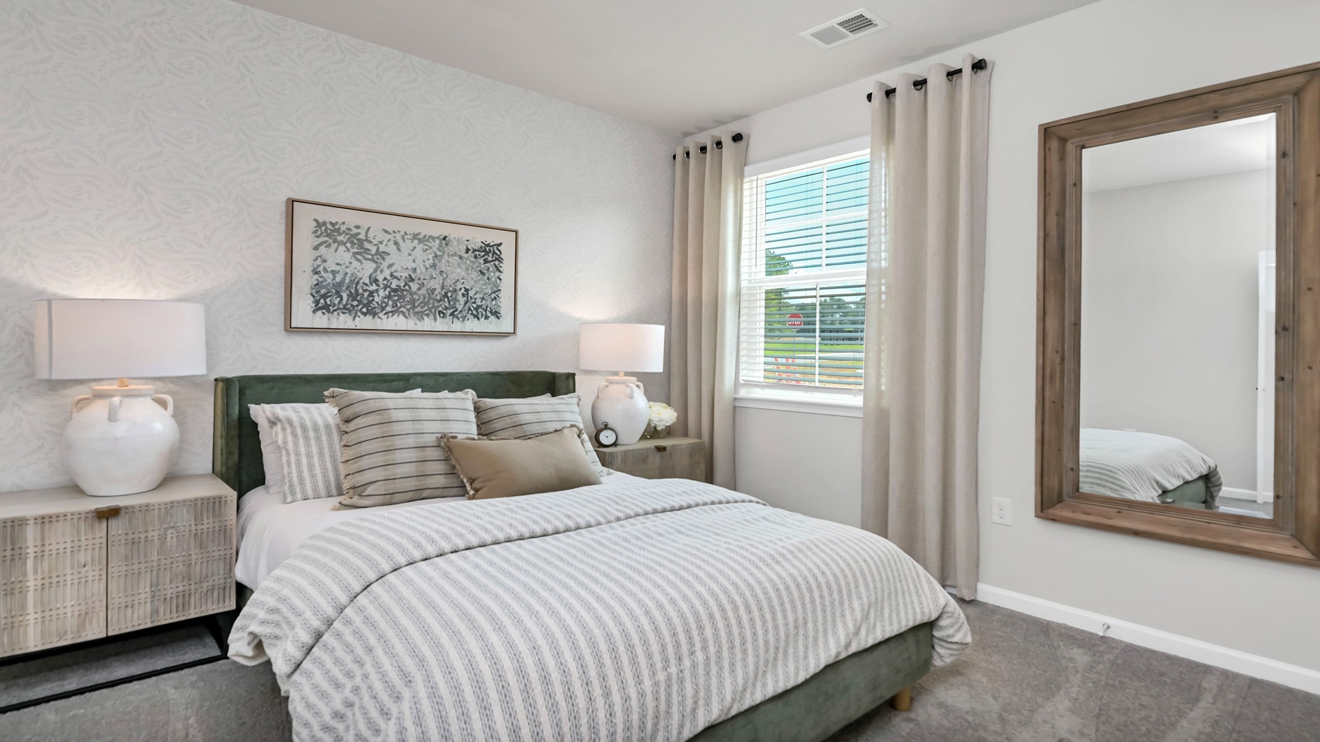 Bedroom 3 features carpet flooring and is staged as a guest suite