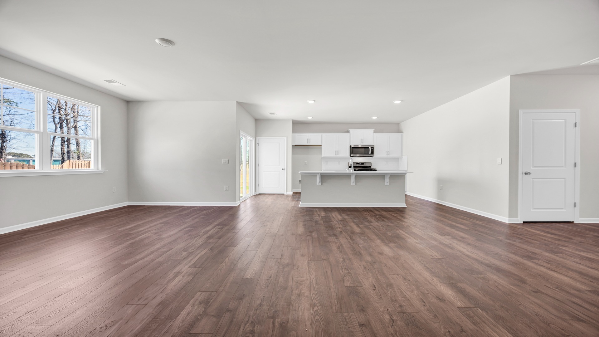 The dining, living, kitchen areas are open concept design finished with Revwood flooring.