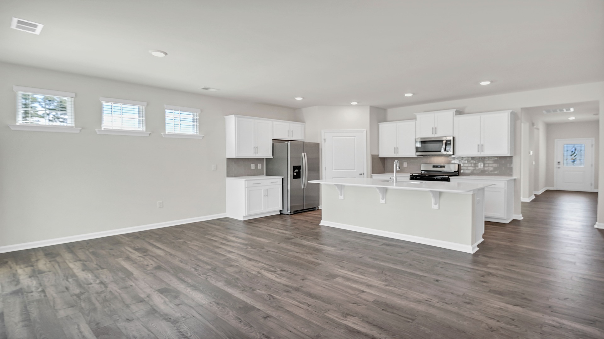 Open kitchen and dining areas with RevWood floors