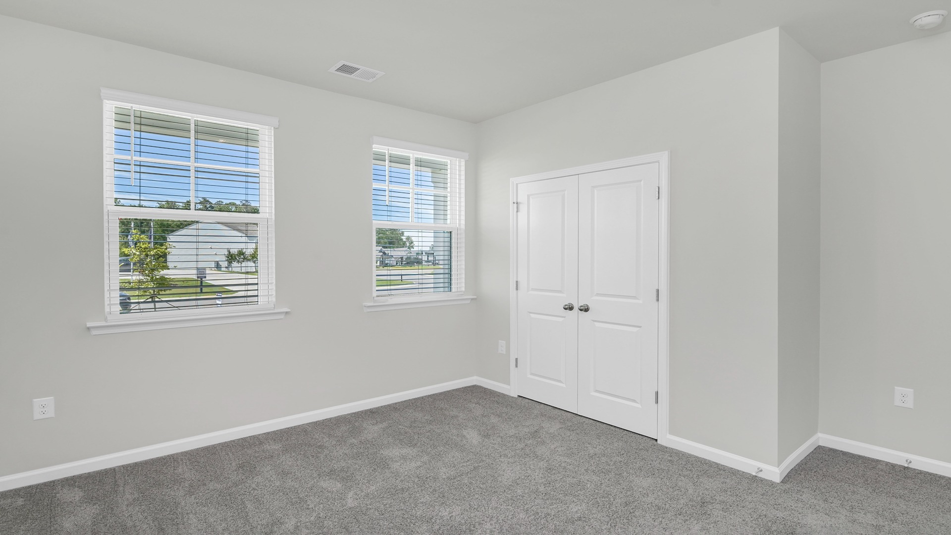 Front bedroom 2 with carpet flooring and window for light