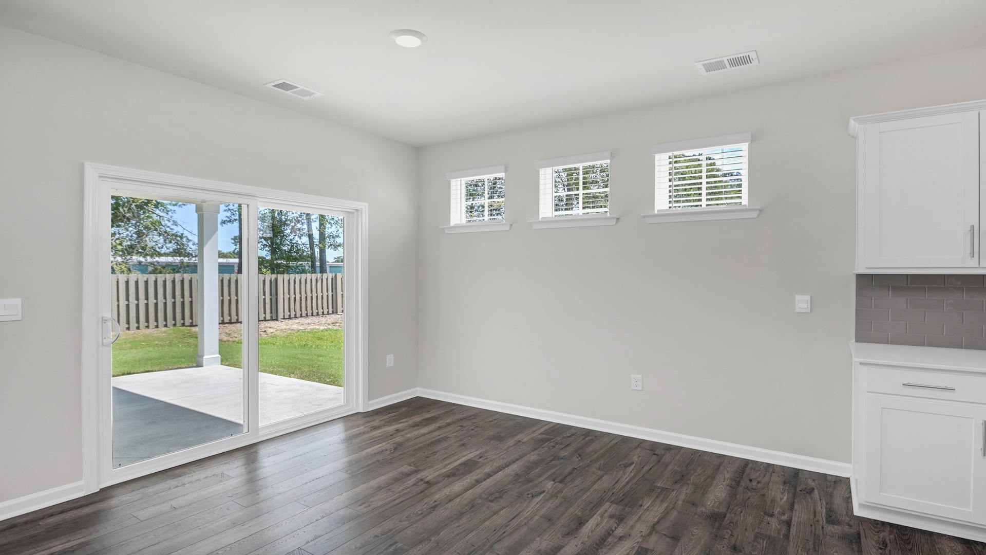 Glass sliding doors in dining area lead to back patio