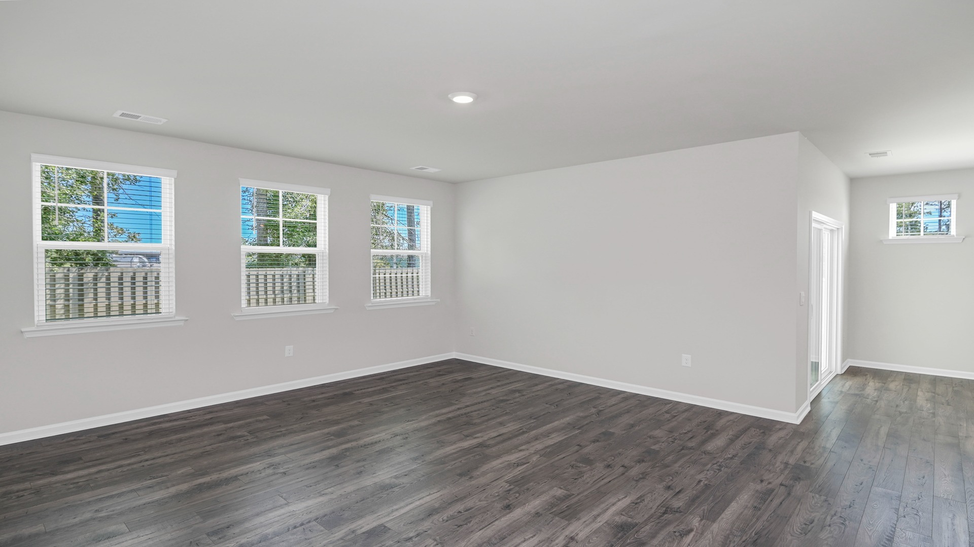 Living area with Revwood flooring and natural light