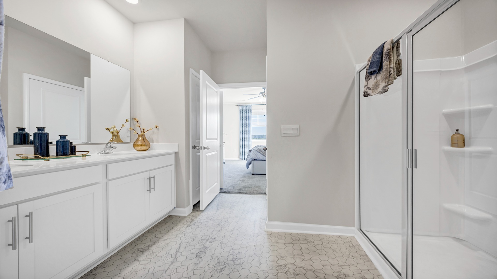 En-suite primary bathroom with standup shower and double vanity
