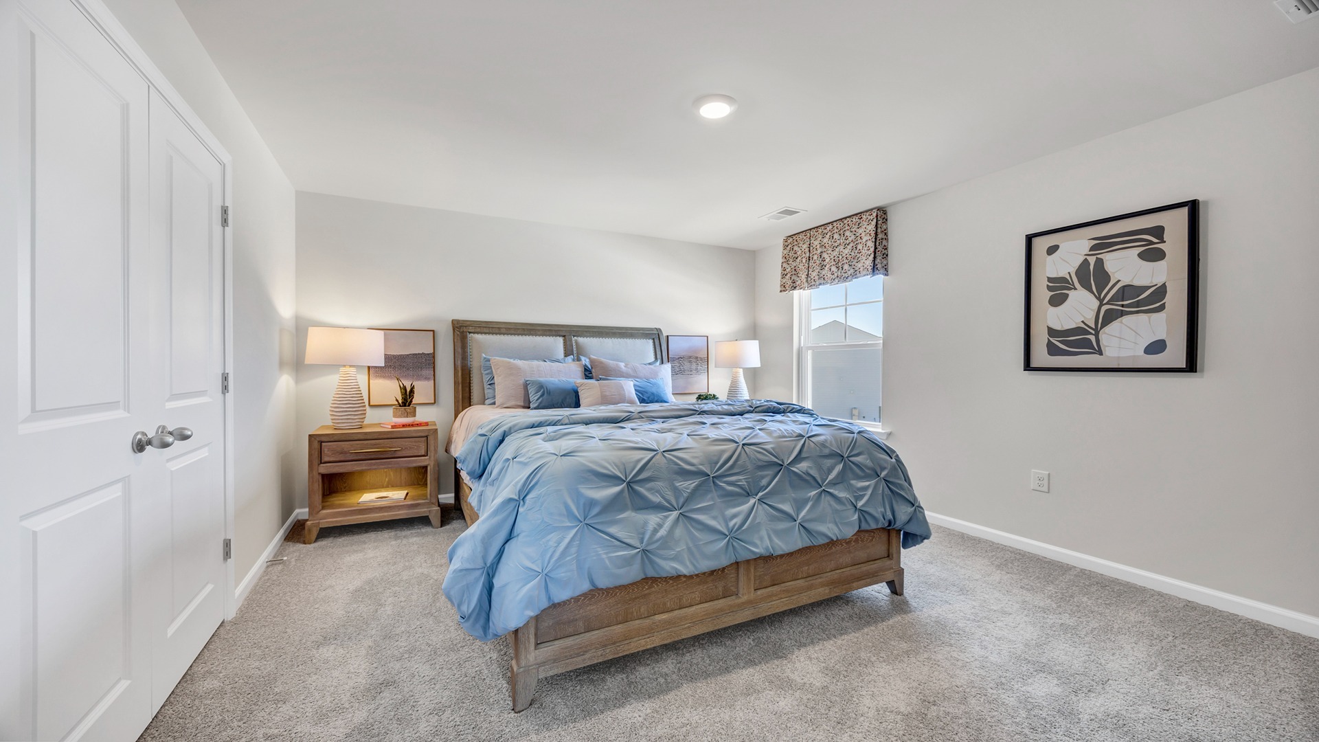 Bedroom 2 upstairs with carpet flooring and French closet doors