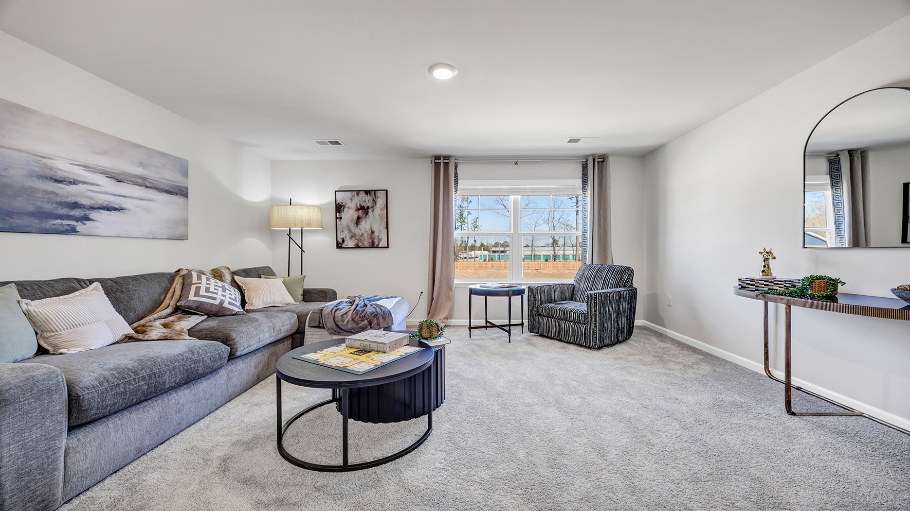 Spacious upstairs loft space with carpet flooring and a window