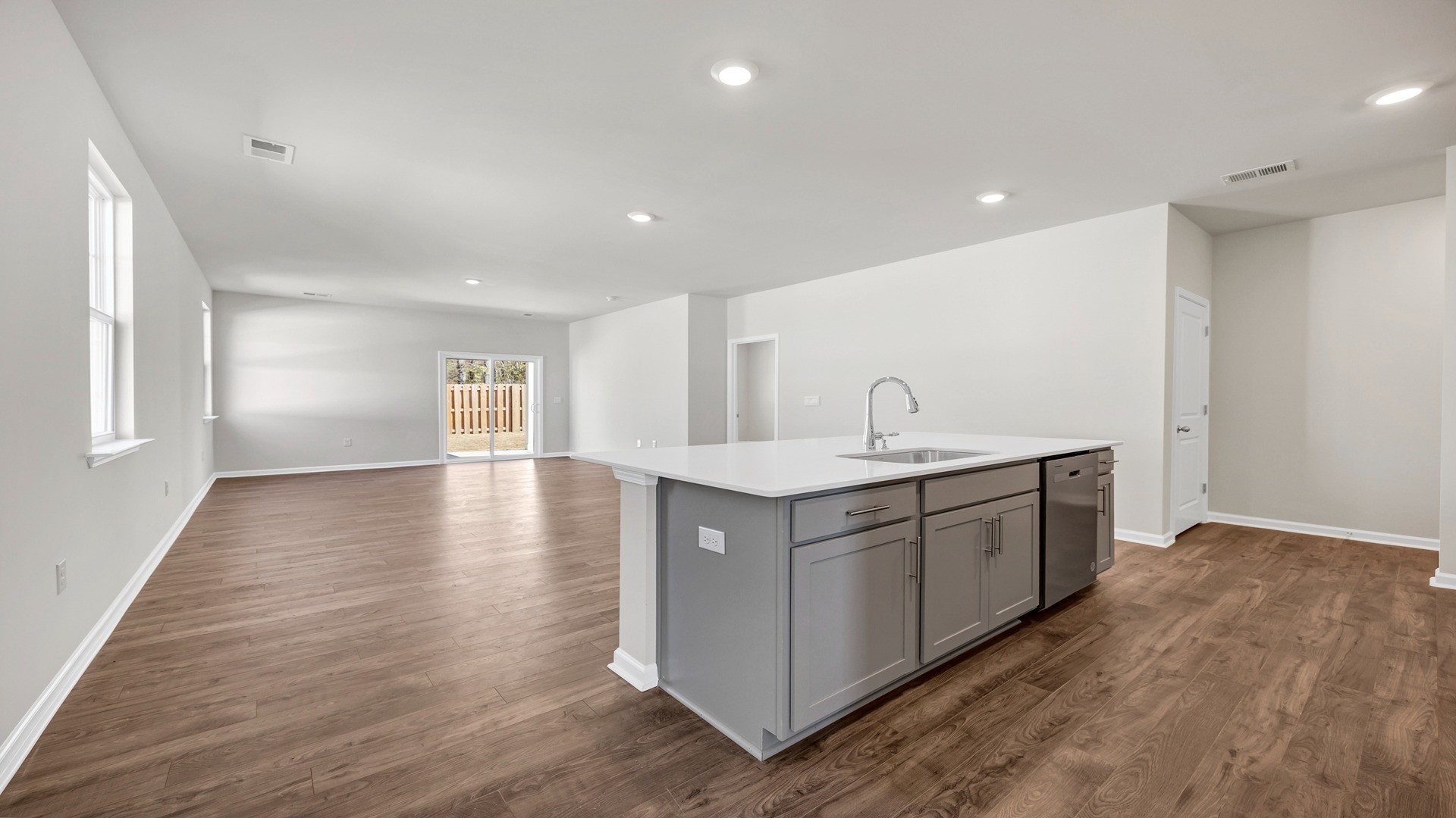 The dining, living, kitchen areas are open concept design finished with Revwood flooring.