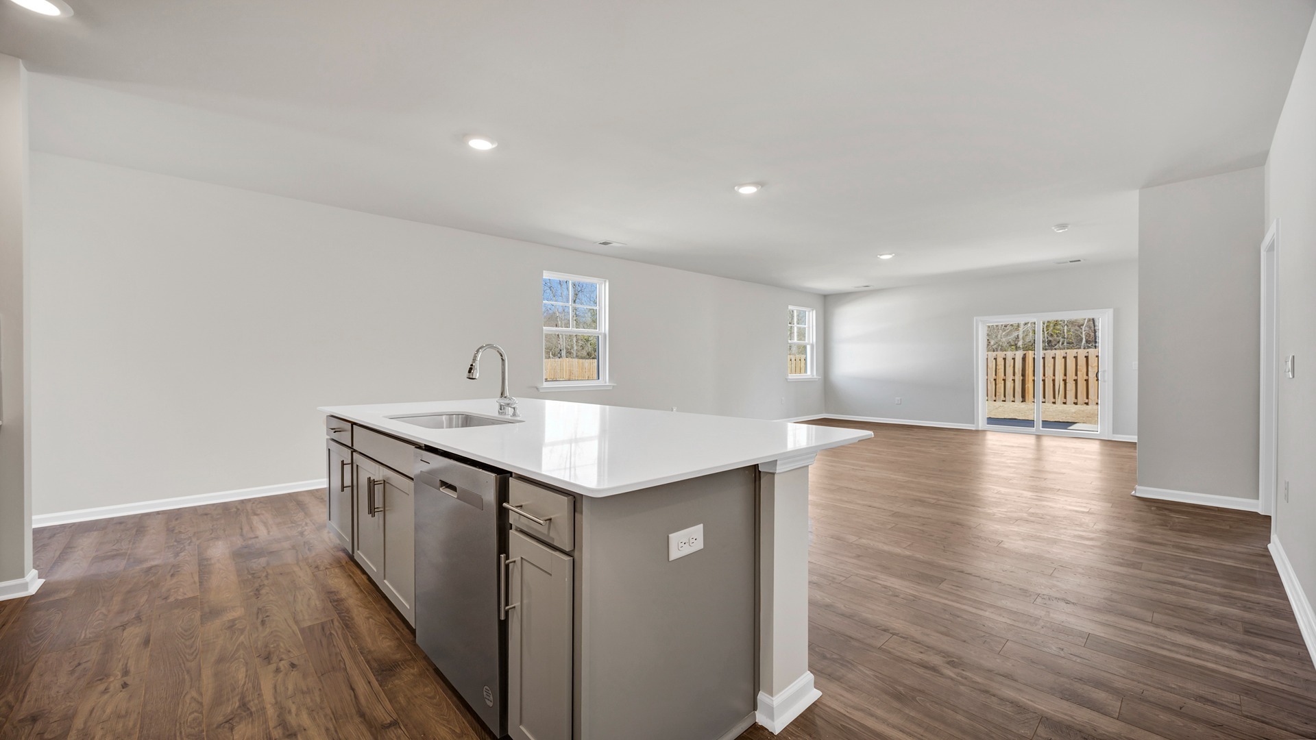 The dining, living, kitchen areas are open concept design finished with Revwood flooring.