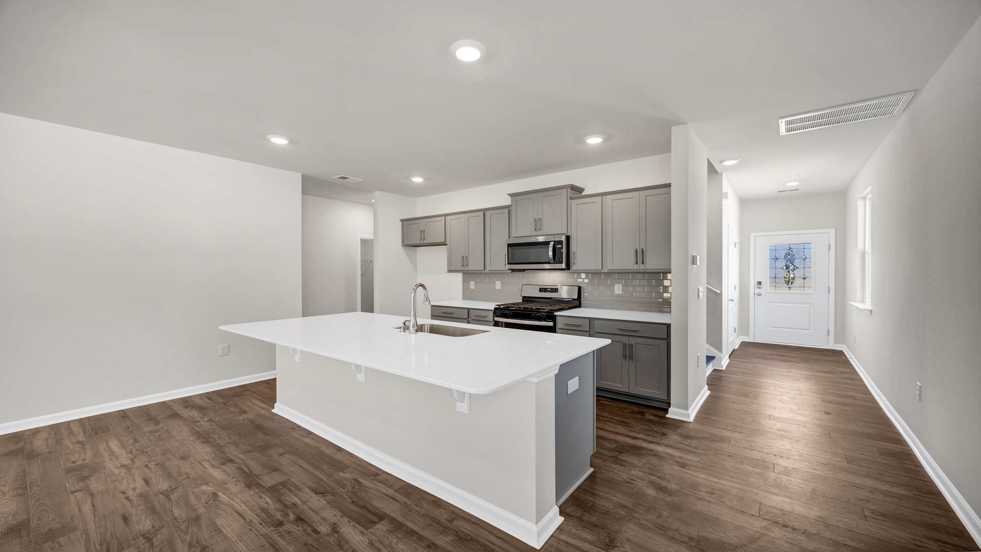 There is also tile backsplash in the kitchen.