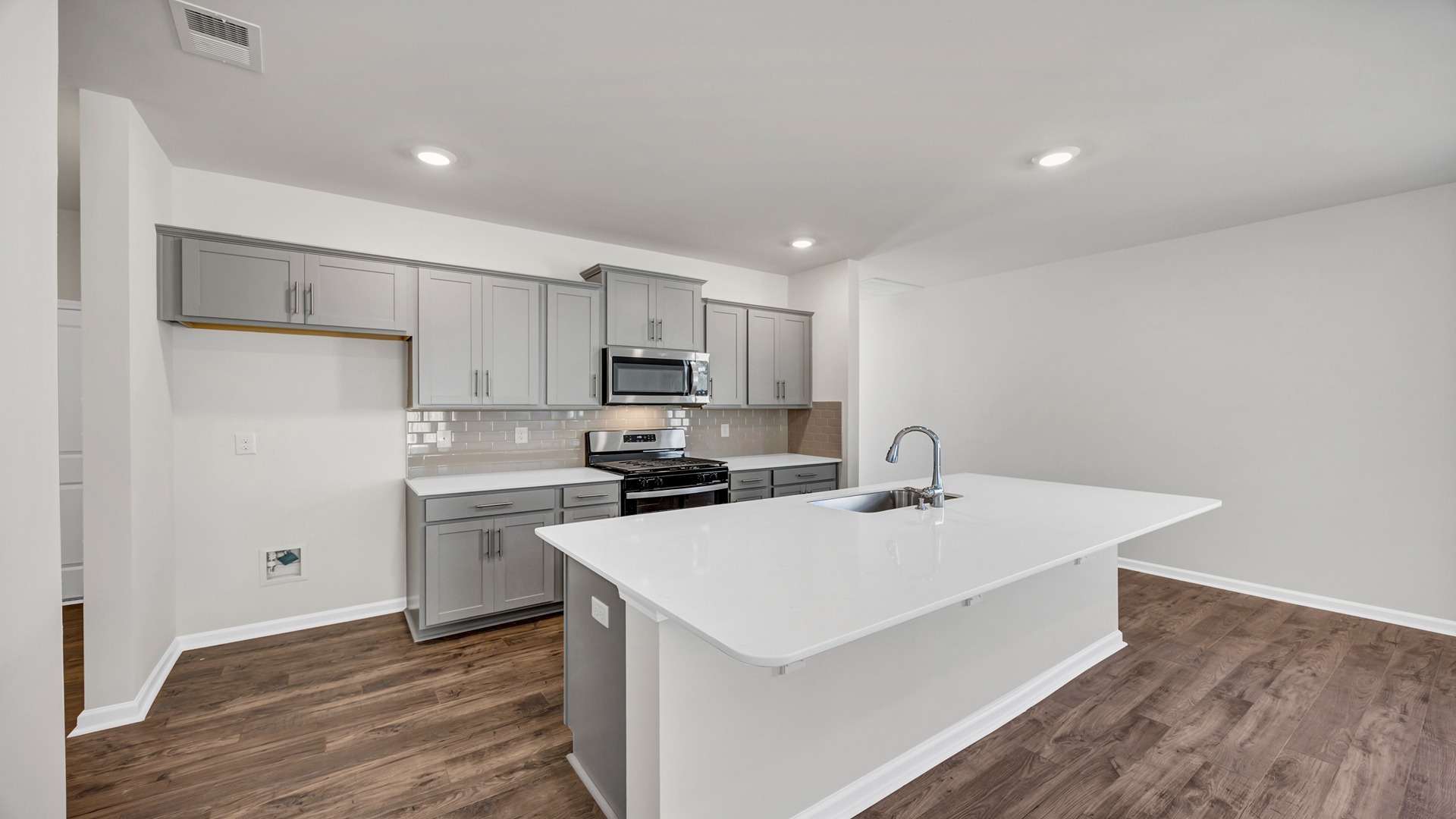 The dining, living, kitchen areas are open concept design finished with Revwood flooring.