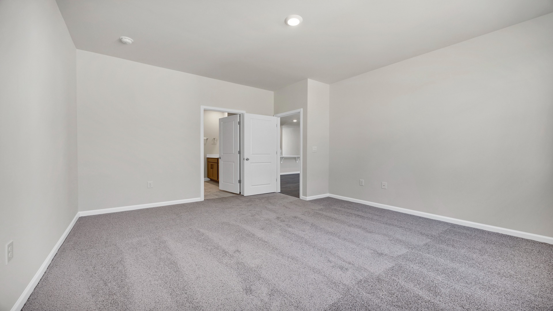 The Primary bedroom is spacious with several windows for natural light.