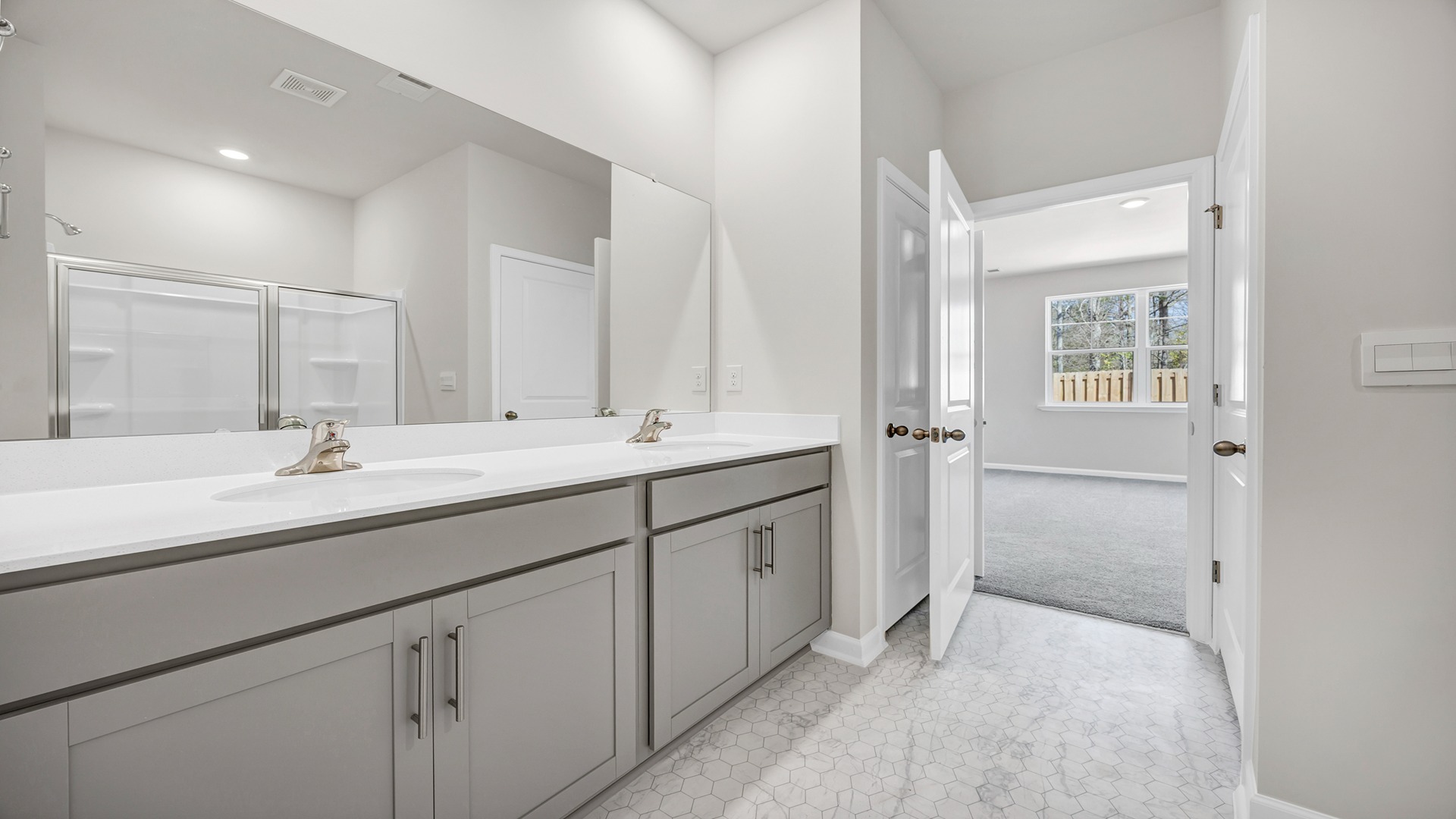 The primary bathroom features a separate room for the toilet.