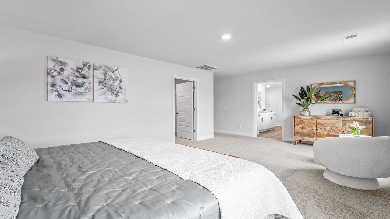 Spacious primary bedroom with natural light
