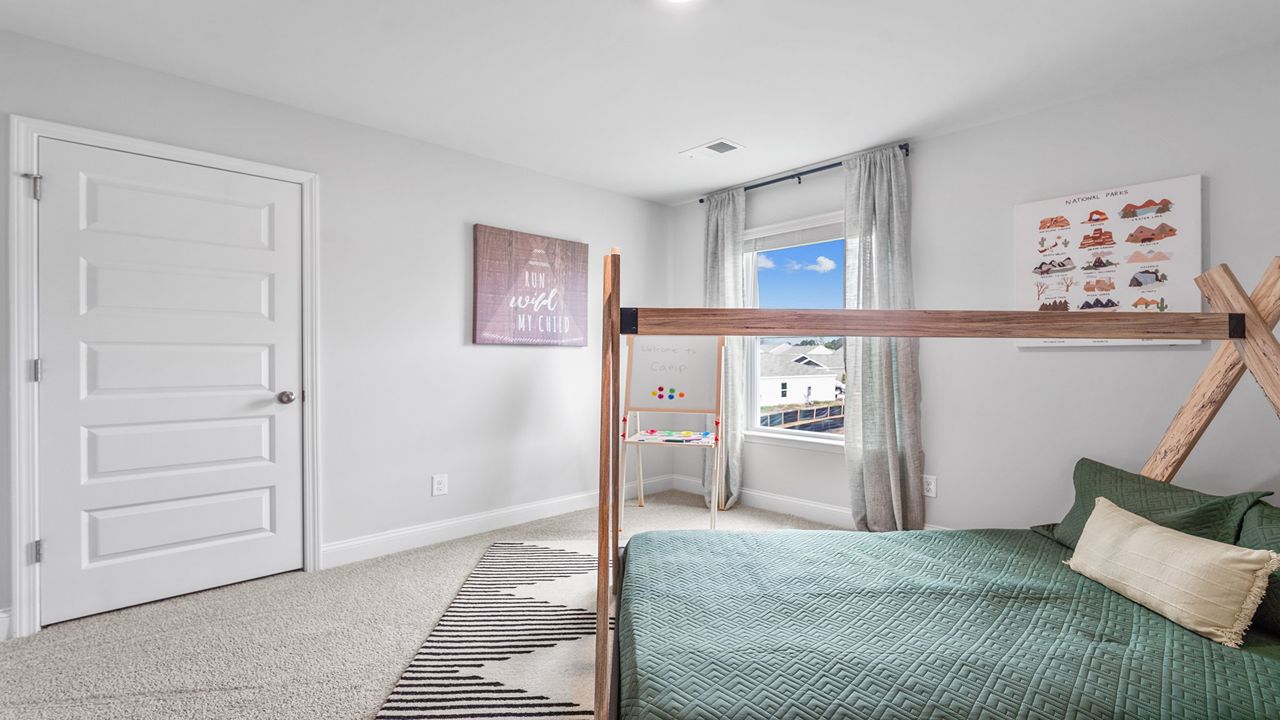 Bedroom 4 with a window and carpet flooring upstairs