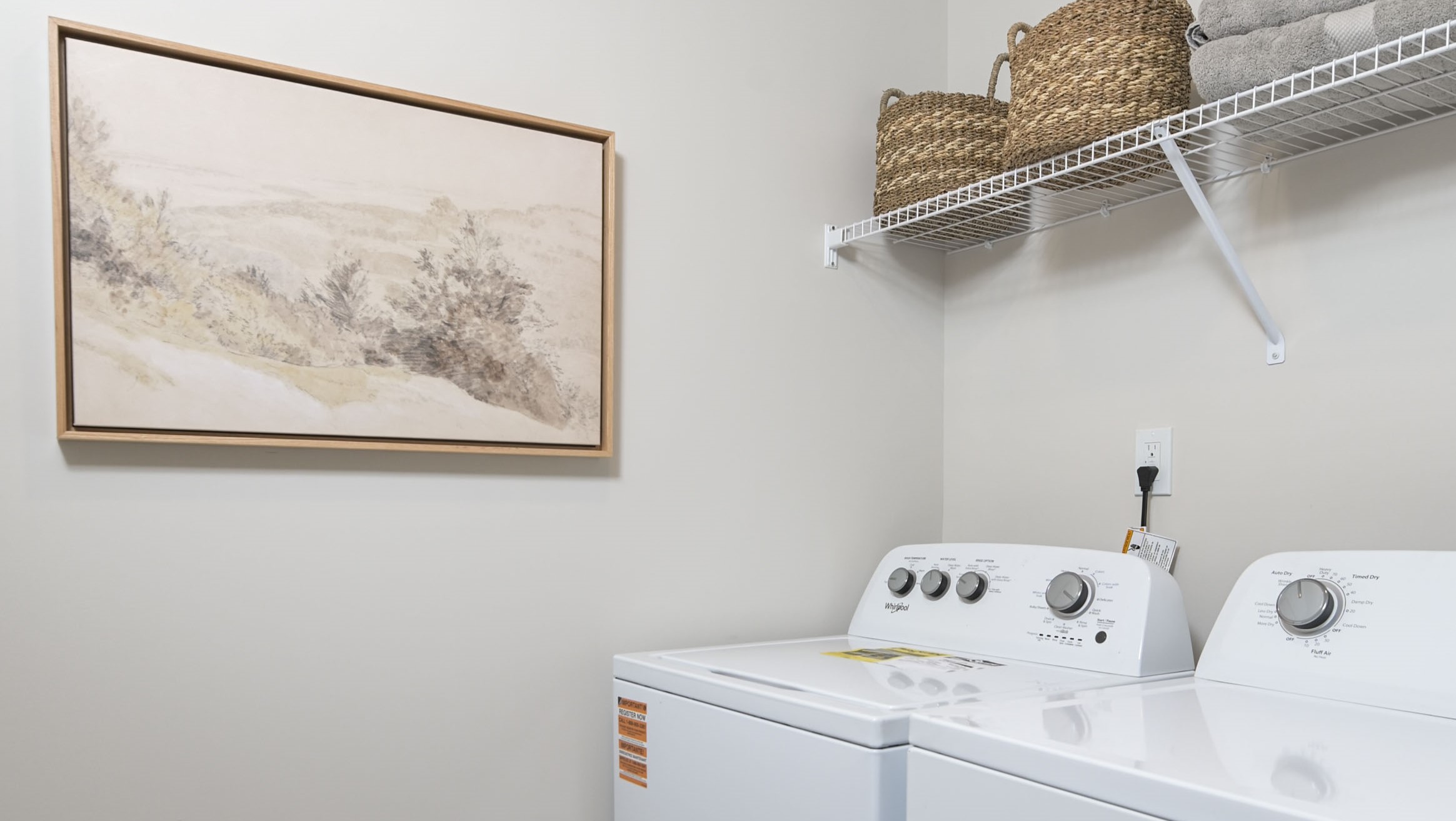 Laundry room upstairs with wire shelving above