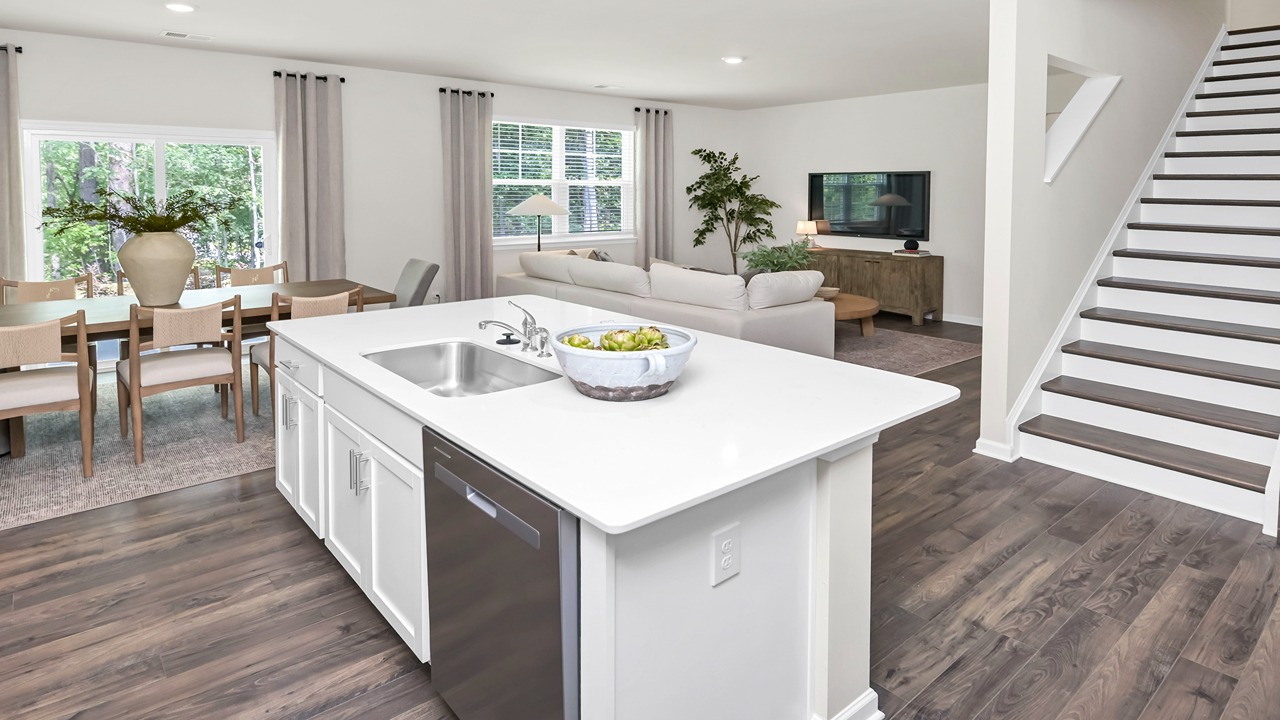 Floating kitchen island overlooks dining and living areas