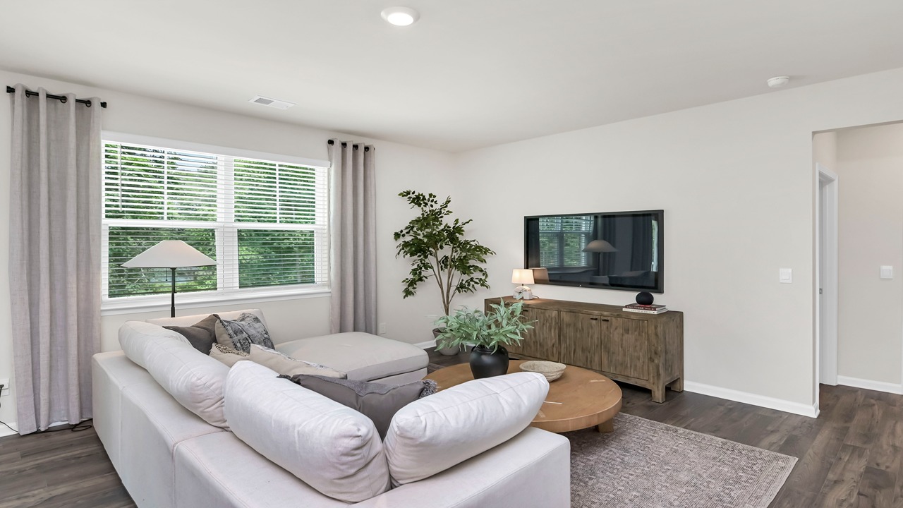 Living area with window for light and RevWood flooring