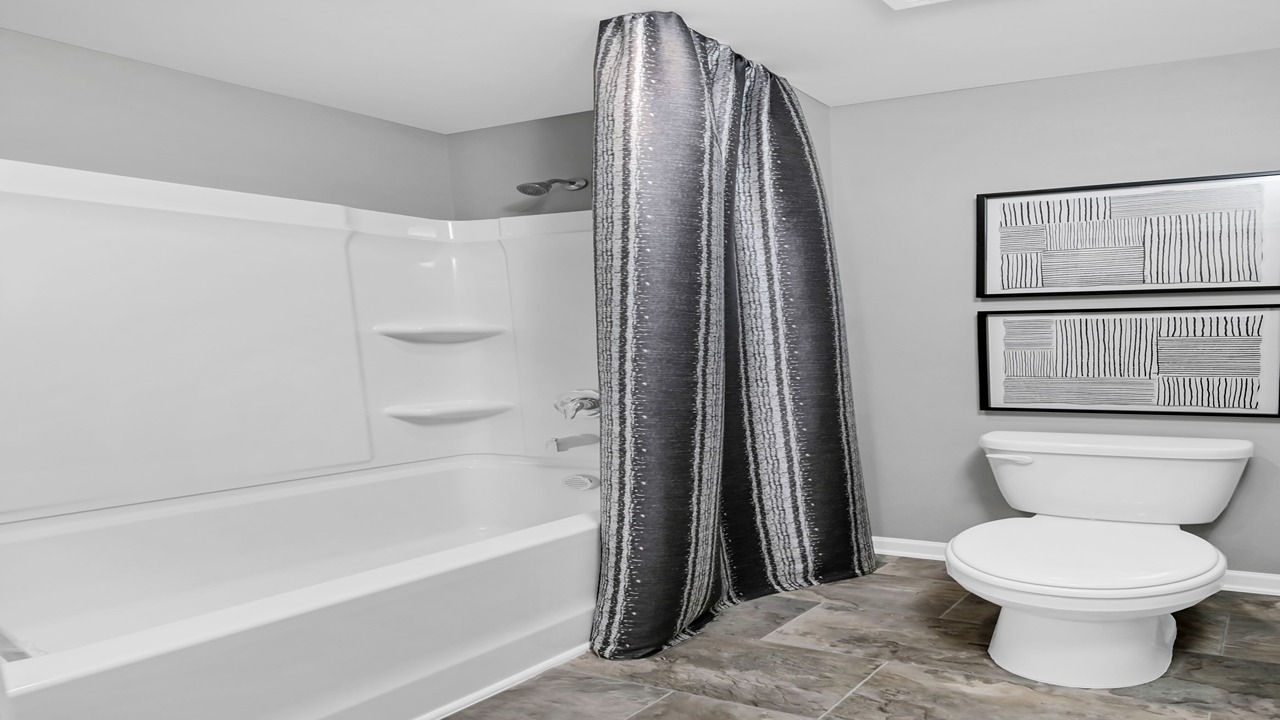 Bathroom 3 upstairs with a shower tub combo and a double vanity