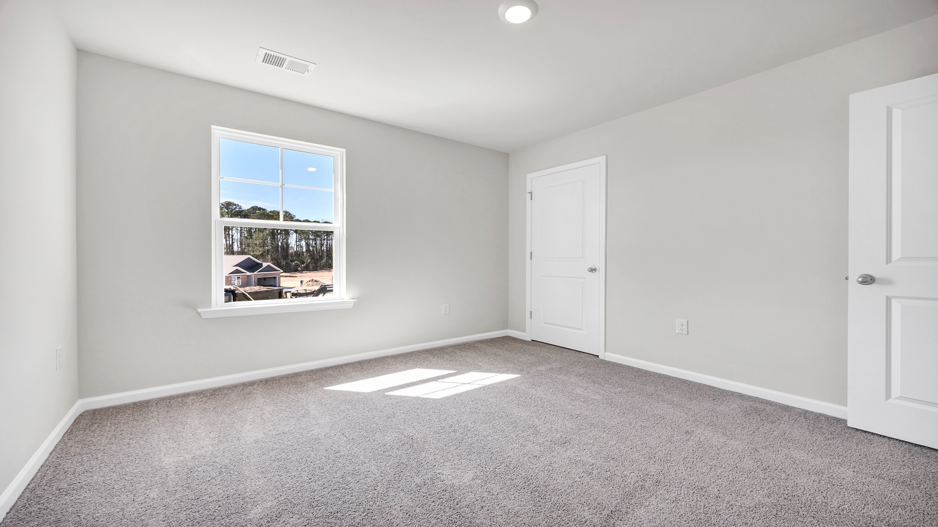 Bedroom 5 upstairs with carpet flooring and a window for light