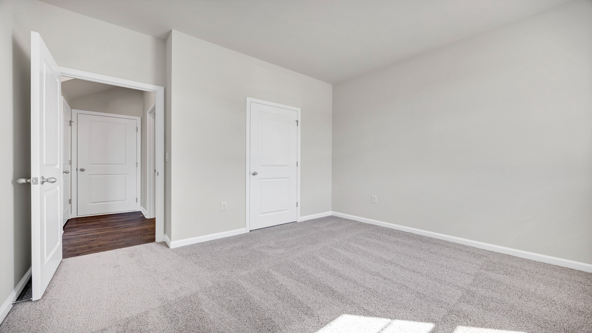 Downstairs bedroom with carpet flooring